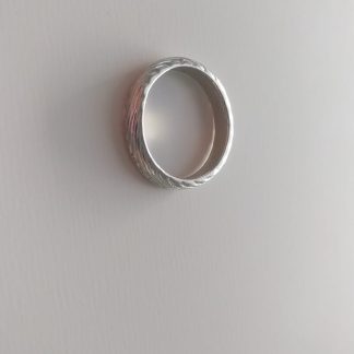 Anillo plateado ancho con textura martillada diagonal