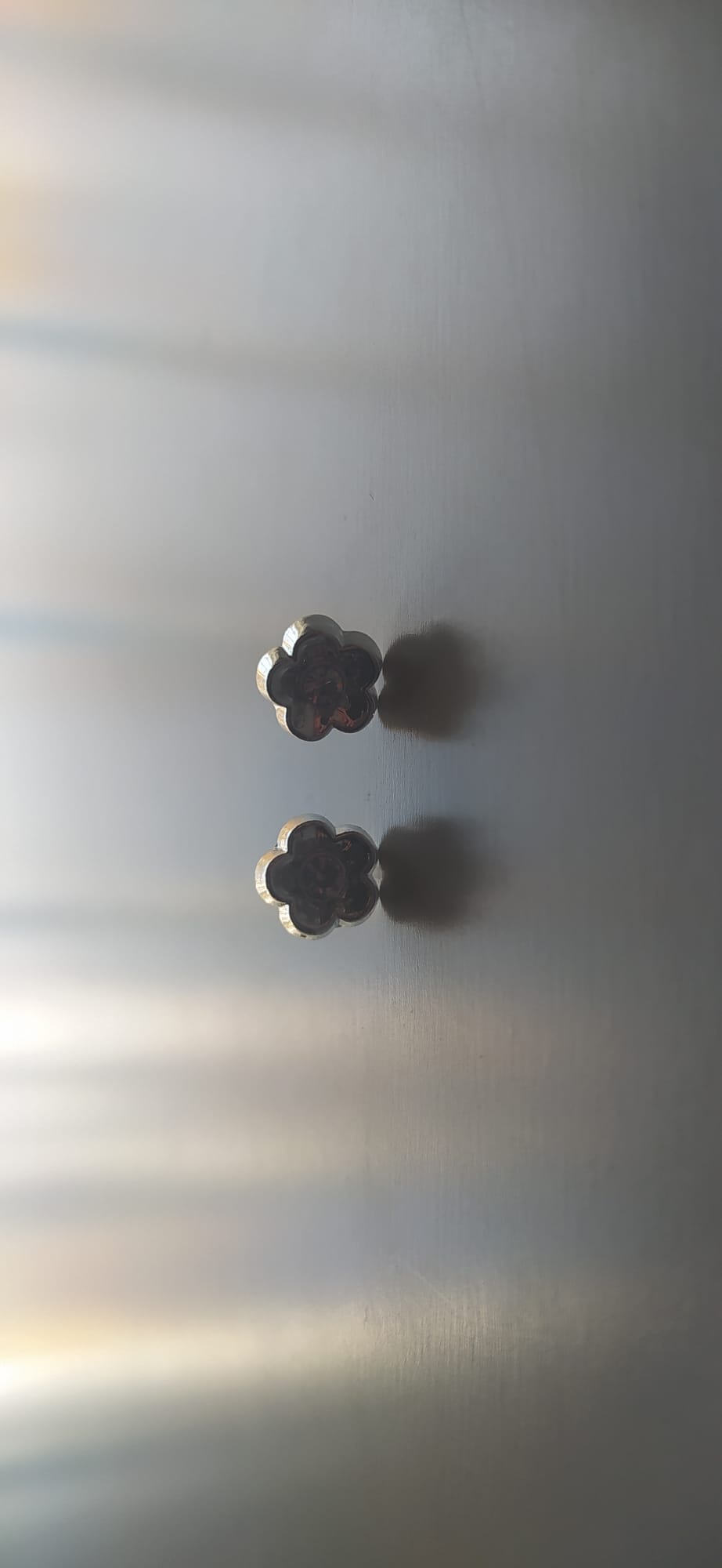 Pendientes plateados en forma de flor con piedra granate