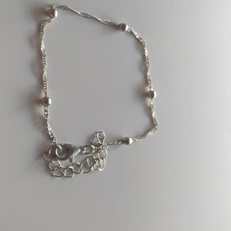 Tobillera de cadena plateada con pequeñas bolitas metálicas